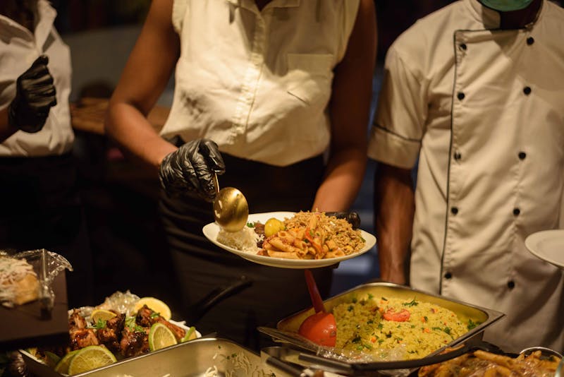 Catering team serving fresh Mexican food at event